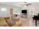 Cozy living room with wood floors, plush seating, and an open doorway to the bedroom at 45 Plantation Ln, Locust Grove, GA 30248