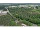 Aerial view showcases the home nestled within a dense forest, emphasizing its secluded setting at 380 Grady Ave, Fayetteville, GA 30214