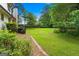 Large, well-maintained backyard surrounded by green trees and a brick border at 380 Grady Ave, Fayetteville, GA 30214