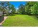Spacious backyard surrounded by a wood fence and green trees at 380 Grady Ave, Fayetteville, GA 30214