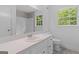 Updated bathroom with sleek vanity, large mirror, and modern fixtures at 380 Grady Ave, Fayetteville, GA 30214