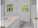 Bright bathroom with wood-look tile flooring and a modern vanity with a white countertop at 380 Grady Ave, Fayetteville, GA 30214