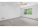 Well lit, empty bedroom featuring a ceiling fan and a window overlooking the outdoors at 380 Grady Ave, Fayetteville, GA 30214
