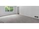 Bright and airy bedroom featuring neutral carpet and a large window with green view at 380 Grady Ave, Fayetteville, GA 30214