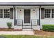 Close-up view of the front entrance with black railings and a step-up porch at 380 Grady Ave, Fayetteville, GA 30214