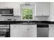 Kitchen features white cabinets, granite counters, stainless steel appliances, and a window over the sink at 380 Grady Ave, Fayetteville, GA 30214