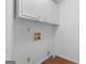 Neutral laundry room with overhead cabinets and hookups for a washer and dryer at 380 Grady Ave, Fayetteville, GA 30214