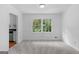 Neutral room with classic paneling and a large window overlooking a green view at 380 Grady Ave, Fayetteville, GA 30214