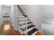 Traditional staircase with wooden steps, white risers, and a classic banister at 380 Grady Ave, Fayetteville, GA 30214