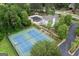 Community with tennis courts, a pool, and a clubhouse surrounded by greenery at 495 Stonehaven Dr, Fayetteville, GA 30215