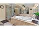 Modern bathroom with a glass-enclosed shower, jacuzzi tub and neutral color scheme at 495 Stonehaven Dr, Fayetteville, GA 30215