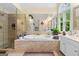 Bright bathroom featuring a soaking tub, separate shower, and a large window for natural light at 495 Stonehaven Dr, Fayetteville, GA 30215