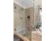 Neutral-toned bathroom featuring a frameless glass shower with built-in shelving at 495 Stonehaven Dr, Fayetteville, GA 30215