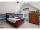 Cozy attic bedroom featuring a bed, dresser, and sports-themed wallpaper border at 495 Stonehaven Dr, Fayetteville, GA 30215