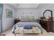 Spacious bedroom with tray ceiling, large window, and decorative bench and matching decor at 495 Stonehaven Dr, Fayetteville, GA 30215