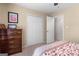 Cozy bedroom with neutral walls, patterned bedding, and a closet at 495 Stonehaven Dr, Fayetteville, GA 30215