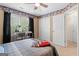 Comfortable carpeted bedroom includes a desk, ceiling fan, and closet for optimal living at 495 Stonehaven Dr, Fayetteville, GA 30215