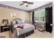 Comfortable bedroom features a ceiling fan, a desk and good natural light from the large window at 495 Stonehaven Dr, Fayetteville, GA 30215