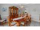 Bright dining room featuring hardwood floors, detailed trim, and a wooden table set with seating for six at 495 Stonehaven Dr, Fayetteville, GA 30215