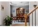 Elegant dining room with a large wooden table, stylish chandelier, and views of the staircase and entryway at 495 Stonehaven Dr, Fayetteville, GA 30215