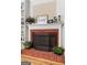 Close-up of the living room fireplace with decorative screen, mantel and surrounding built-in shelving at 495 Stonehaven Dr, Fayetteville, GA 30215
