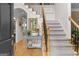 Elegant foyer featuring hardwood floors, a staircase with iron balusters, and a stylish console table at 495 Stonehaven Dr, Fayetteville, GA 30215