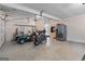 Well-lit garage interior with ample space for vehicles, storage, and a convenient refrigerator at 495 Stonehaven Dr, Fayetteville, GA 30215