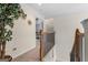 Upstairs hallway with wood banister overlooking another room with a decorated tree at 495 Stonehaven Dr, Fayetteville, GA 30215