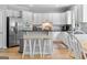 Beautiful kitchen with white cabinets, stainless steel appliances, counter seating and natural light at 495 Stonehaven Dr, Fayetteville, GA 30215