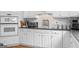 Modern kitchen includes white cabinets, stainless steel appliances, and granite countertops at 495 Stonehaven Dr, Fayetteville, GA 30215