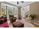 Bright living area with hardwood floors, a large bay window, and comfortable seating arrangements perfect for relaxation at 495 Stonehaven Dr, Fayetteville, GA 30215