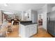 An open concept kitchen and living area featuring wood floors and bright light at 495 Stonehaven Dr, Fayetteville, GA 30215