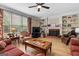 Cozy living room featuring a fireplace, built-in shelves, and a large window for natural light at 495 Stonehaven Dr, Fayetteville, GA 30215