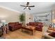 Cozy living room with hardwood floors, a ceiling fan, and access to the bright, open kitchen at 495 Stonehaven Dr, Fayetteville, GA 30215