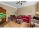 Cozy living room with hardwood floors, neutral walls, comfortable seating, and a ceiling fan for added comfort at 495 Stonehaven Dr, Fayetteville, GA 30215