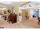 An open floor plan that includes a piano, living area and kitchenette on top of carpeted flooring at 495 Stonehaven Dr, Fayetteville, GA 30215