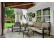 Covered back patio with comfortable seating and views of the backyard at 495 Stonehaven Dr, Fayetteville, GA 30215
