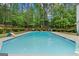 Fenced backyard with a large in-ground pool and lush landscaping at 495 Stonehaven Dr, Fayetteville, GA 30215