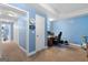 Functional study area with a desk, chair, and closet, ideal for a home office or creative space with blue walls at 495 Stonehaven Dr, Fayetteville, GA 30215