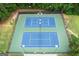 Aerial shot of the community's well-maintained tennis courts surrounded by lush greenery at 495 Stonehaven Dr, Fayetteville, GA 30215