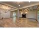 Open living room with hardwood floors, exposed beams and brick fireplace at 1147 Tanglewood Rd, Jonesboro, GA 30236