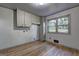 Versatile room with hardwood floors, window views, and built-in cabinets, ideal for laundry or storage needs at 1147 Tanglewood Rd, Jonesboro, GA 30236