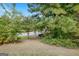 Peaceful backyard featuring lush foliage, mature trees, and green lawn at 1716 Anniston Dr, Mcdonough, GA 30253