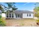 Large backyard featuring a covered patio and mature trees at 1716 Anniston Dr, Mcdonough, GA 30253