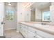 Bathroom featuring double sinks, large mirror, and a window with natural light at 1716 Anniston Dr, Mcdonough, GA 30253