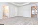 Carpeted Primary bedroom featuring a trey ceiling and adjoining bathroom at 1716 Anniston Dr, Mcdonough, GA 30253
