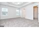 Light-filled carpeted bedroom featuring trey ceilings and a closet at 1716 Anniston Dr, Mcdonough, GA 30253