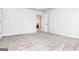 Bright, carpeted bedroom with a glimpse of the fireplace in the next room at 1716 Anniston Dr, Mcdonough, GA 30253