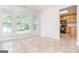 Bright dining area featuring tile floors, large windows, and seamless connectivity to the adjacent kitchen at 1716 Anniston Dr, Mcdonough, GA 30253