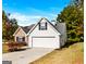 Charming two-story home with a well-maintained lawn, white siding, and a two-car garage on a sunny day at 1716 Anniston Dr, Mcdonough, GA 30253
